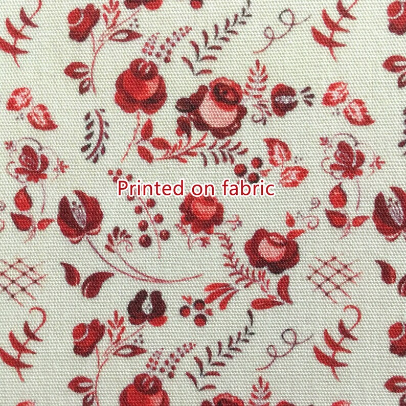 May include: Red floral pattern printed on white fabric. The pattern features small red roses, leaves, and berries.