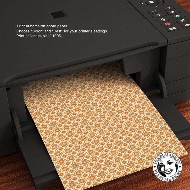 May include: A printer with a sheet of paper with a geometric pattern in shades of orange and white. The text on the printer reads: "Print at home on photo paper. Choose "Color" and "Best" for your printer's settings. Print at "actual size" 100%"