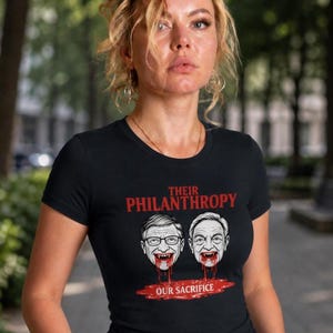 Puede incluir: Camiseta negra con el texto "Their Philanthropy Our Sacrifice" en rojo. La camiseta presenta un gráfico de dos caras con sangre goteando de sus bocas. La persona lleva la camiseta.