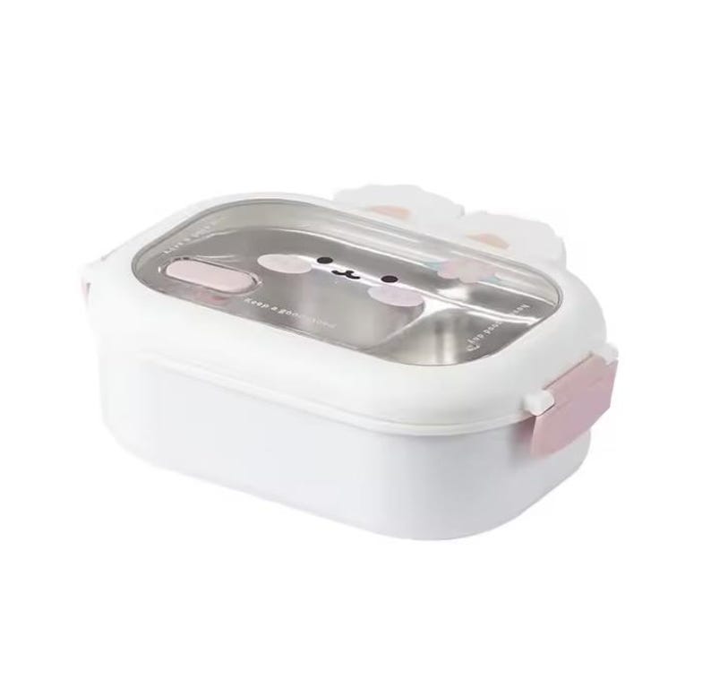 May include: White rectangular lunch box with a clear lid and a stainless steel interior. The lid features a cartoon bunny face design with pink accents. The lunch box has a pink clasp and bunny ear details.