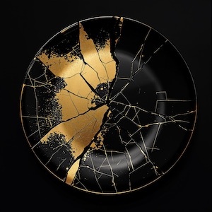May include: A black plate with a shattered design, featuring gold accents. The gold is splattered across the plate, with fine gold lines tracing the cracks. The plate is set against a black background.