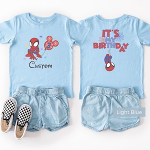 Light blue kids t-shirt with Spiderman birthday design, custom name and age print, “It’s My Birthday” back design, styled outfit with shorts and shoes