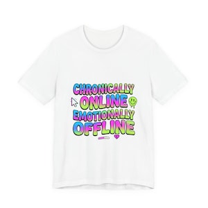 May include: A white t-shirt with the text "Chronically Online Emotionally Offline" in a colorful, gradient font. The design includes a cursor, a smiley face, a heart, and a bar.
