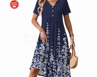 May include: A navy blue knee-length dress with short sleeves, a V-neckline, and three buttons at the chest. The fabric features a white and light blue floral pattern that is concentrated at the hem and extends upward in vertical floral stems.