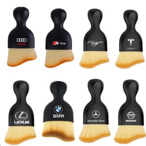 May include: A white ceramic mug with a black handle and the text "But first, coffee" in a black, handwritten-style font. The mug is on a white surface.