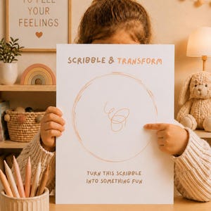 May include: A child holds a white paper with the text "SCRIBBLE & TRANSFORM" and a circular scribble design. The text "TURN THIS SCRIBBLE INTO SOMETHING FUN" is below the design. Colored pencils are in a beige ceramic cup.