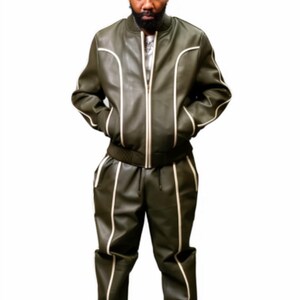 May include: Olive green leather bomber jacket and matching pants with white piping. The jacket has a zipper closure and the pants have a drawstring waist. The outfit is paired with white sneakers.