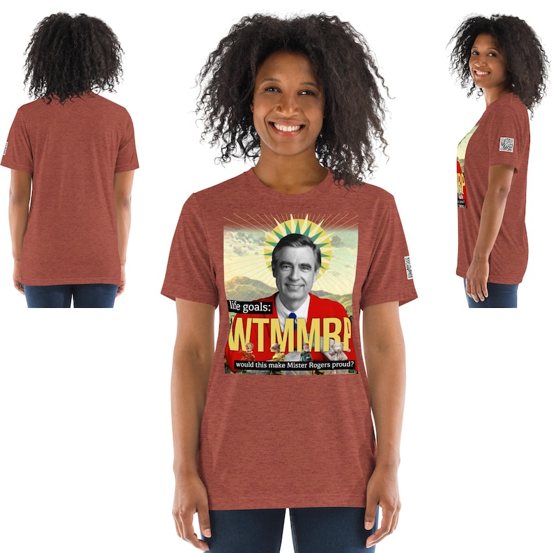 May include: A heather red t-shirt featuring a graphic of Fred Rogers with the text "life goals: WTMMRP" and "would this make Mister Rogers proud?" The shirt is displayed from multiple angles.