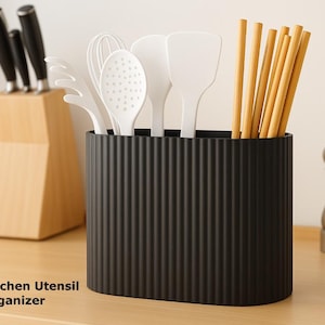 May include: A white ceramic mug with a black handle and the text "But First, Coffee" in a handwritten style. The mug is on a white surface. The mug is 4 inches tall.