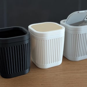 May include: A set of three ceramic mugs with a speckled, matte finish. The mugs are in shades of blue, green, and gray. Each mug has a simple, modern design and a comfortable handle. Perfect for coffee or tea.