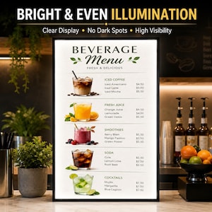 May include: A rectangular LED light box display featuring a beverage menu with categories for iced coffee, fresh juice, smoothies, soda, and cocktails. The sign displays text including BRIGHT & EVEN ILLUMINATION, Clear Display, No Dark Spots, High Visibility, and BEVERAGE MENU FRESH & DELICIOUS with various drink illustrations.