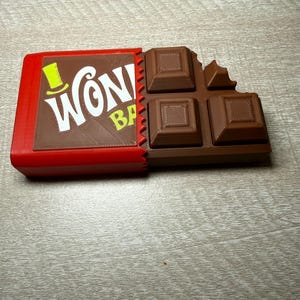 Wonka bar fidget clicker 3D printed. Use code 3DFORFREE1 for free shipping when you purchase 2 or more items.