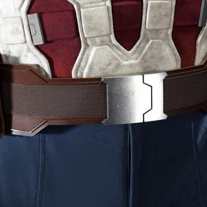 May include: A close-up of a brown utility belt with a silver buckle. The belt has two pouches and is worn over a red, white, and blue costume. The buckle is rectangular with a geometric design.