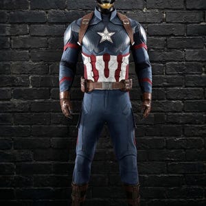 May include: A Captain America costume in blue and red. The outfit includes a helmet with the letter "A", a chest star, and brown leather details. The figure stands against a black brick wall. The costume is a replica.