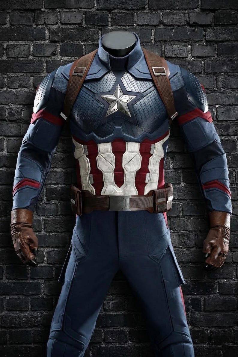 May include: A Captain America costume featuring a blue and red armored suit with a white and red striped midsection. The costume includes a silver star emblem, brown leather gloves, and a brown belt.
