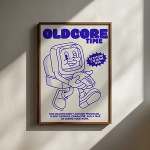 May include: A framed poster featuring a blue line art illustration of a cartoon computer character holding a mouse. The text reads OLDCORE TIME, BE PATIENT I'M FROM 1990, and THIS MACHINE DIDN'T JUST RUN PROGRAMS... IT BUILT PATIENCE, CHARACTER, AND A FEAR OF LOSING YOUR WORK.