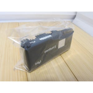 May include: A black Intel Pentium II processor in a clear plastic bag. The processor has the Intel logo and the words "pentium II" printed on it. The processor is rectangular with a series of small, black fins on top.