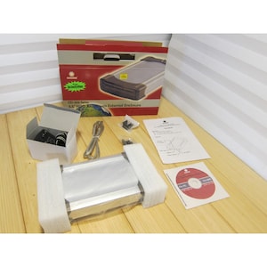 May include: A silver 3.5" HDD aluminum external enclosure with accessories, including a box, cables, and a CD-ROM. The box is red and white with the product name printed on it. The enclosure is packaged in white foam.