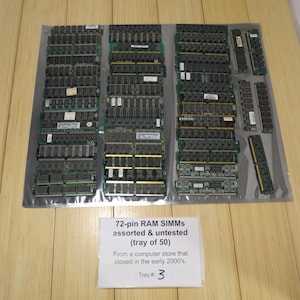 May include: A collection of assorted and untested 72-pin RAM SIMMs, likely from the early 2000s, arranged on a clear plastic sheet. The image includes a label stating "Tray # 3" and the description "72-pin RAM SIMMS assorted & untested (tray of 50)".