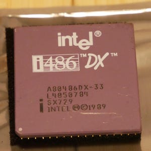 May include: A close-up of a vintage Intel i486 DX processor. The processor has a mauve-colored top with the Intel logo and "i486 DX" printed in white. The text "A80486DX-33", "L4050784", "SX729", and "INTEL © 1989" are also visible.