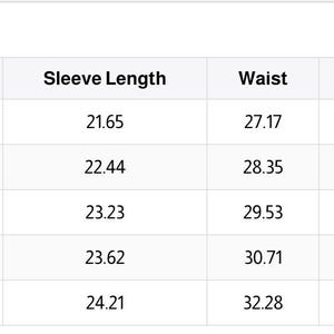May include: A white table displays a size chart with measurements in inches. The chart includes sizes XS to XL, listing top length, bust, sleeve length, waist, hips, and pant length. The measurements are in inches.