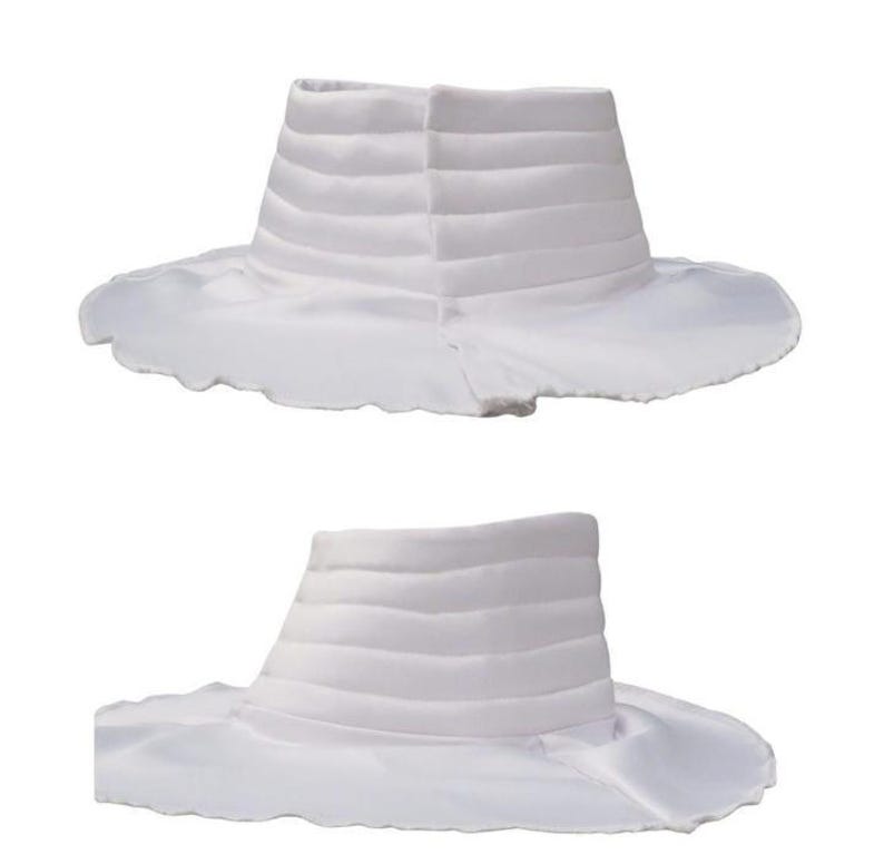 May include: Two white fabric collars featuring a high, structured neck with horizontal quilted stitching and a wide, flat, circular base that flares outward. The collars are made of a smooth, solid white material with a clean, finished edge.