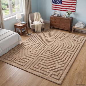 May include: A rectangular area rug featuring a raised, textured maze pattern in a solid beige color. The design consists of interconnected lines and pathways that create a labyrinthine motif across the entire surface of the floor covering.