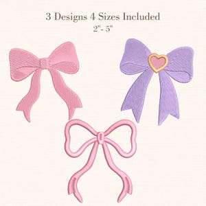 May include: Three embroidered bow designs in pink and purple. One bow is light pink, another is purple with a gold heart, and the third is a lighter pink. The text reads "3 Designs 4 Sizes Included 5 cm - 12.7 cm"