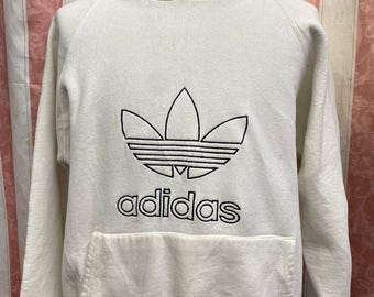 Bluza z kapturem Adidas Trefoil Vintage z lat 90. w kolorze kremowo-białym, wyprodukowana w USA, rozmiar M, haftowane logo, rzadka estetyka lat 90.