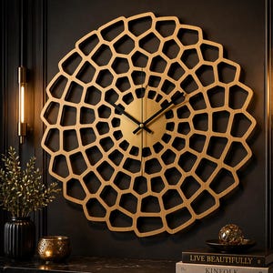 Puede incluir: Un reloj de pared Voronoi de madera y acrílico dorado. El reloj presenta un patrón geométrico único en un cálido color dorado, con manecillas negras y un centro dorado. El texto "VORONOI WALL CLOCK" se muestra en la parte superior.