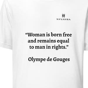 May include: White t-shirt with the text "Woman is born free and remains equal to man in rights." attributed to Olympe de Gouges. The shirt also features the brand name "NYVAYRA" in black.