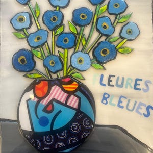 May include: A vibrant artwork featuring a bouquet of blue flowers in a patterned vase. The vase is set against a light background with the words "FLEURES BLEUES" in blue. The flowers have yellow centers and green stems.
