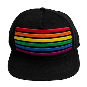 May include: Black baseball cap featuring a rainbow flag design. The rainbow flag is embroidered across the front of the cap, with horizontal stripes in red, orange, yellow, green, blue, and purple. The cap has a curved brim and a button on top.