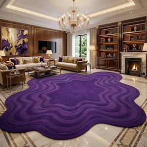 May include: A large, purple, wavy-edged area rug dominates a luxurious living room. The rug's design features concentric, undulating lines in varying shades of purple. The room includes a fireplace, bookshelves, and elegant furniture.