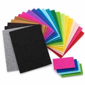 May include: A collection of rectangular felt sheets arranged in a fan shape, featuring a wide spectrum of colors including black, gray, brown, pink, purple, blue, green, yellow, and red, with smaller matching felt rectangles placed separately.