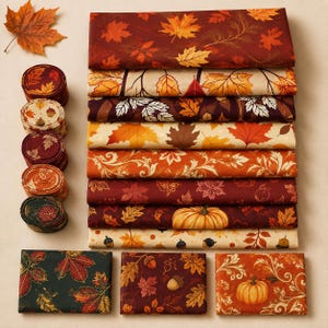May include: A collection of fabric bundles and rolls featuring autumn-themed patterns. The designs include various maple leaves, pumpkins, and acorns in shades of orange, red, brown, cream, and dark green, arranged in a neat, organized display.