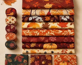 May include: A collection of fabric bundles and rolls featuring autumn-themed patterns. The designs include various maple leaves, pumpkins, and acorns in shades of orange, red, brown, cream, and dark green, arranged in a neat, organized display.