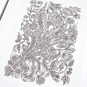 May include: Detailed black and white floral illustration featuring stylized flowers, leaves, and ribbons. The artwork is framed and presented on a white background, showcasing intricate patterns and textures. The design is reminiscent of vintage botanical prints.