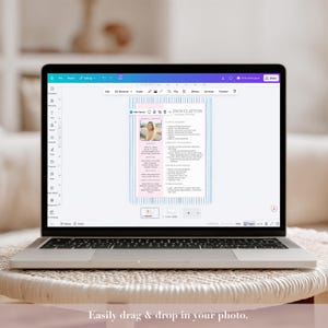 May include: A laptop displaying a resume template with a photo and text. The resume design features a pink and blue striped background. The text on the screen reads "JASON CLAYTON". The laptop is open on a white table.