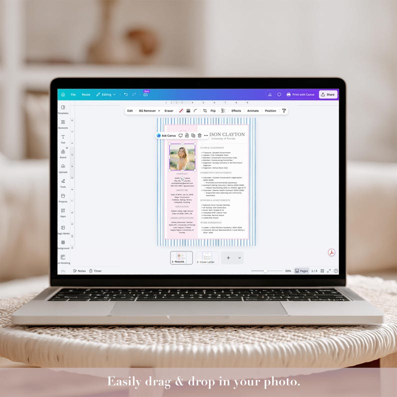 May include: A laptop displaying a resume template with a photo and text. The resume design features a pink and blue striped background. The text on the screen reads "JASON CLAYTON". The laptop is open on a white table.