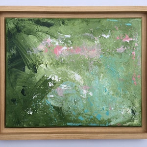 May include: Abstract painting with a wooden frame. The artwork features a textured surface with a blend of green, pink, and blue brushstrokes. The colors are layered, creating depth and visual interest. The wooden frame is light-colored.