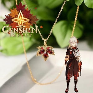 May include: A gold necklace featuring a maple leaf pendant set with red gemstones. The necklace is shown with the "Genshin Impact" logo and a character illustration. The pendant is approximately 2.5 cm in length.