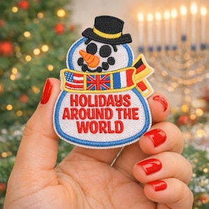 May include: A snowman patch with a black top hat, carrot nose, and a scarf featuring the flags of the USA, UK, France, and Germany. The patch reads "Holidays Around The World" in red letters on a white background with a blue border.