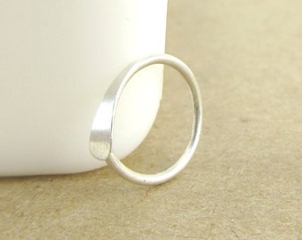 May include: A silver ring with a simple, rounded design. The ring is made of a smooth, polished metal.