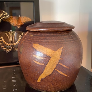 May include: A set of three ceramic mugs with a speckled, matte finish. The mugs are in shades of cream, light gray, and dark gray. Each mug has a simple, minimalist design, perfect for coffee or tea.