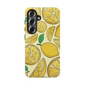 May include: A rectangular smartphone case featuring a repeating pattern of yellow lemon slices, wedges, and whole lemons with green leaves on a pale yellow background. The case has a black camera module cutout positioned on the upper left side.