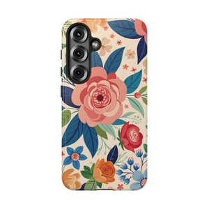 May include: A phone case with a floral design. The case features a cream-colored background with a pattern of pink, red, orange, and blue flowers, along with green and blue leaves. The phone case has a camera module with three lenses.