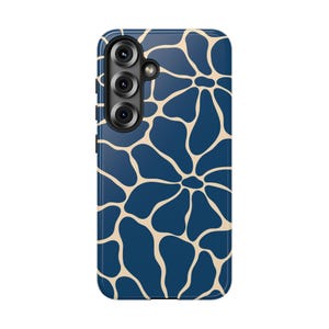 May include: A navy blue phone case with a beige, organic pattern. The case has a glossy finish and features a camera module with three lenses. The design resembles a giraffe's spots, offering a stylish and unique look.
