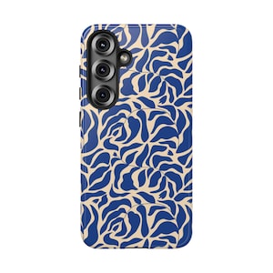 May include: A rectangular smartphone case featuring a repeating pattern of dark blue organic leaf shapes against a light beige background. The case includes a vertical cutout on the upper left side for a triple camera lens array and a flash component.
