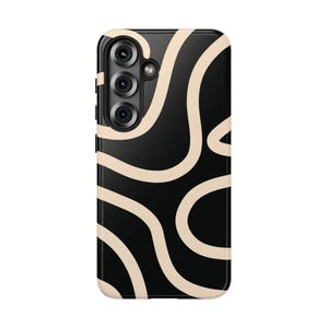 May include: A black phone case with a cream-colored, abstract wavy pattern. The case has a camera module with three lenses and a flash. The design is modern and minimalist, suitable for various phone models.